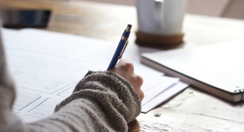 Person writing on a paper