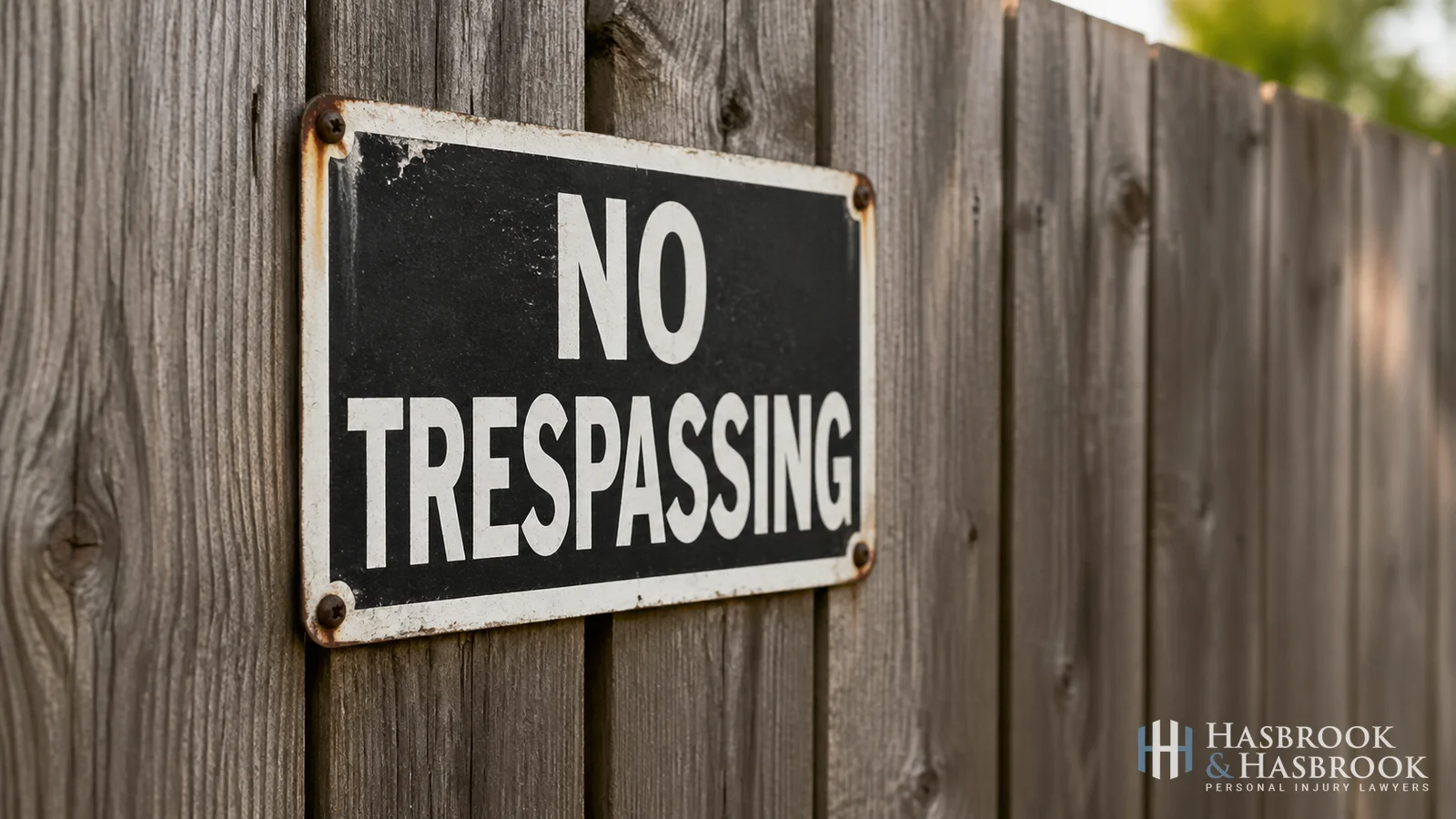 No trespassing sign mounted on a wood fence