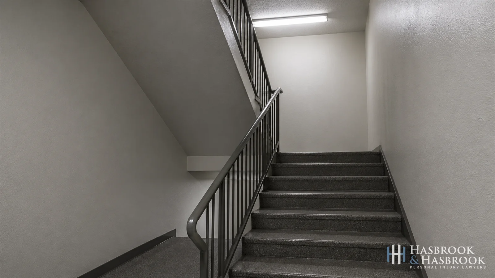 Common-area stairwell showing handrail condition and lighting