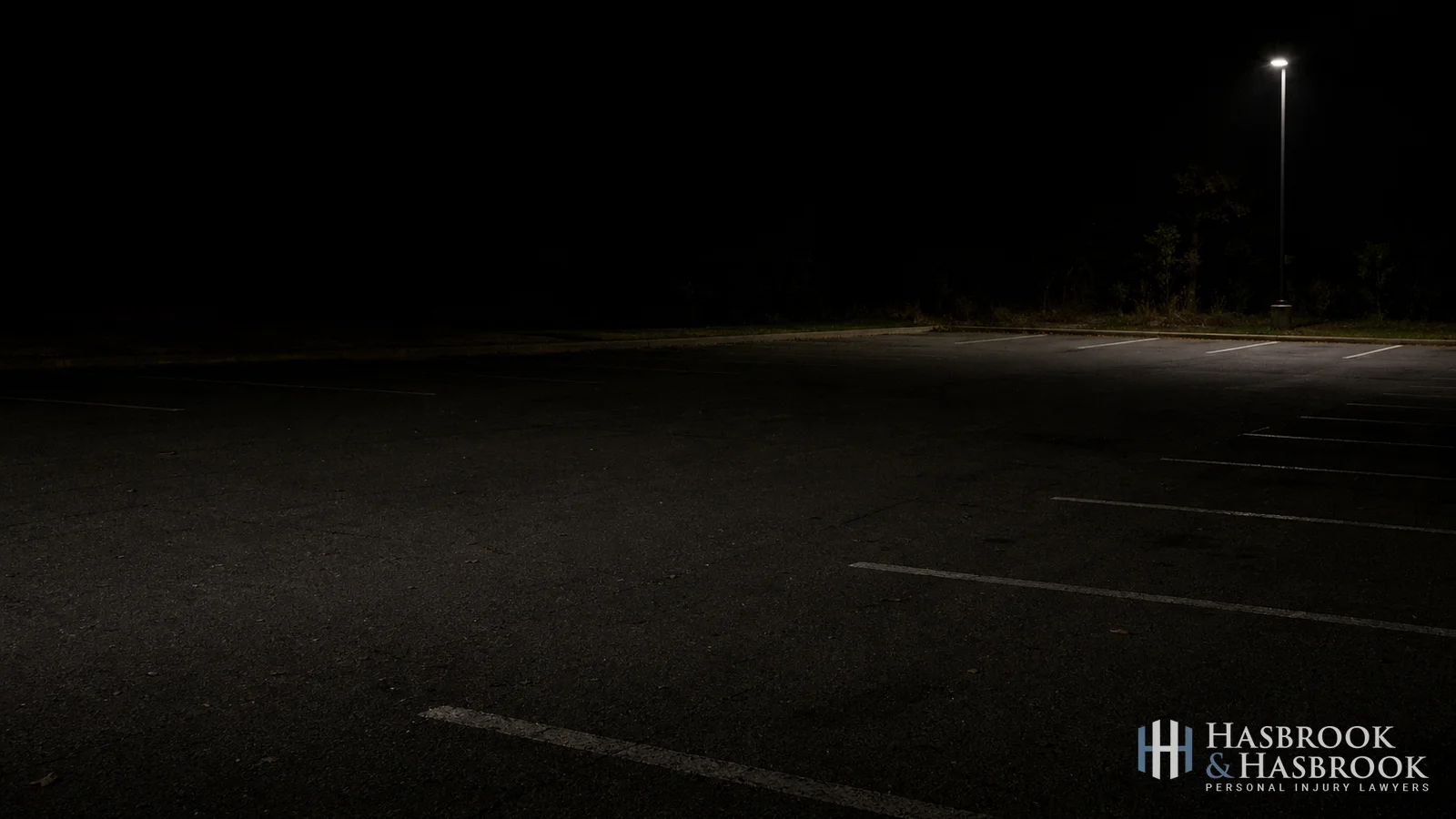 2: Dimly-lit commercial parking lot at night - suggested alt: "Dimly-lit commercial parking lot at night in Oklahoma City"