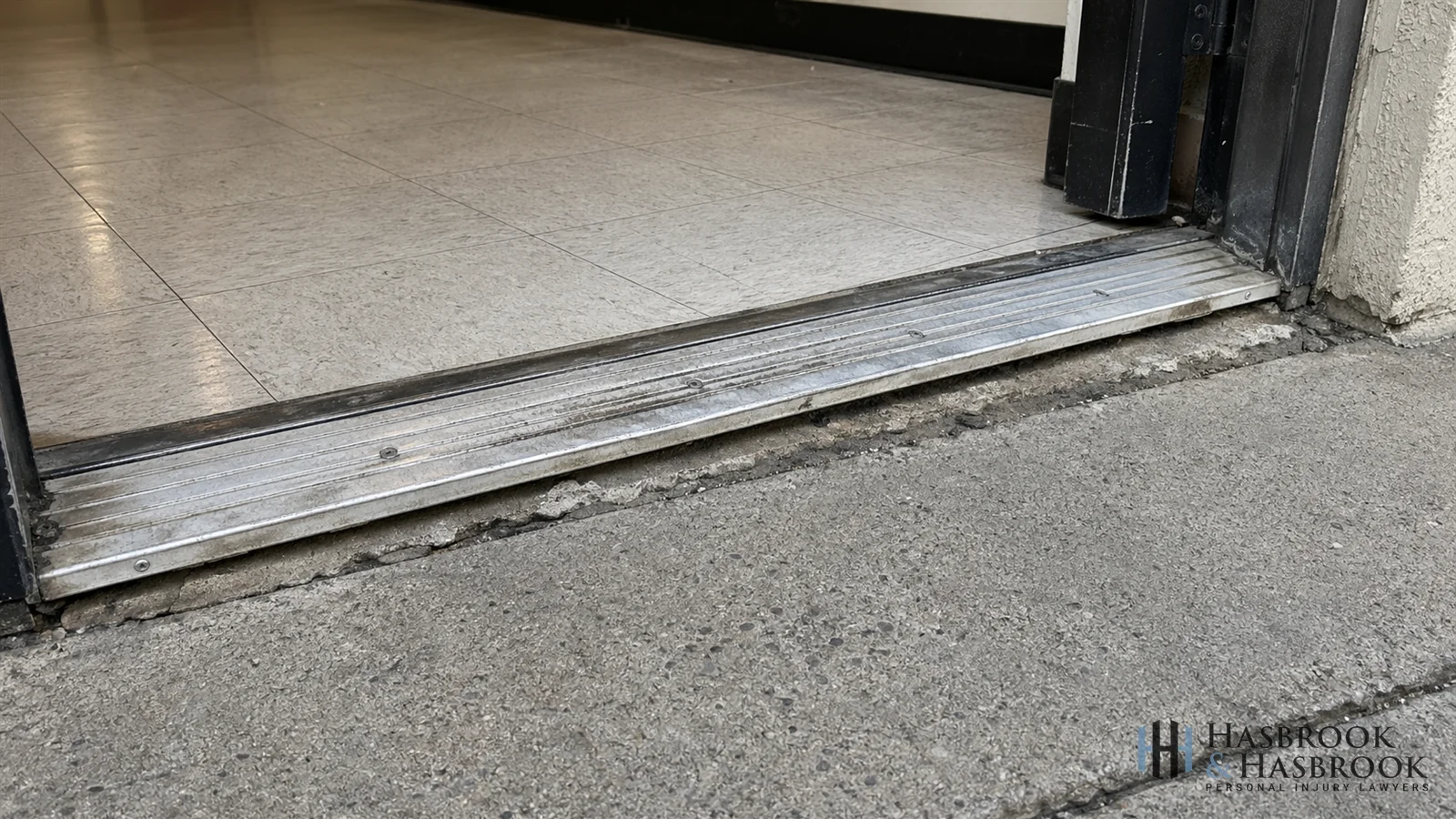 Uneven commercial doorway threshold showing floor transition
